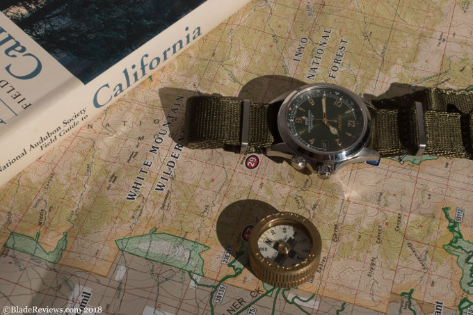The Seiko Alpinist on a map with a compass