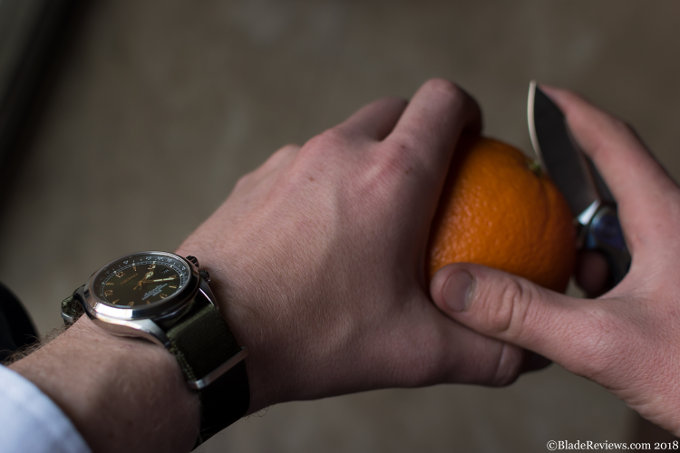 Seiko Alpinist and Rike Thor pocket knife peeling an Orange